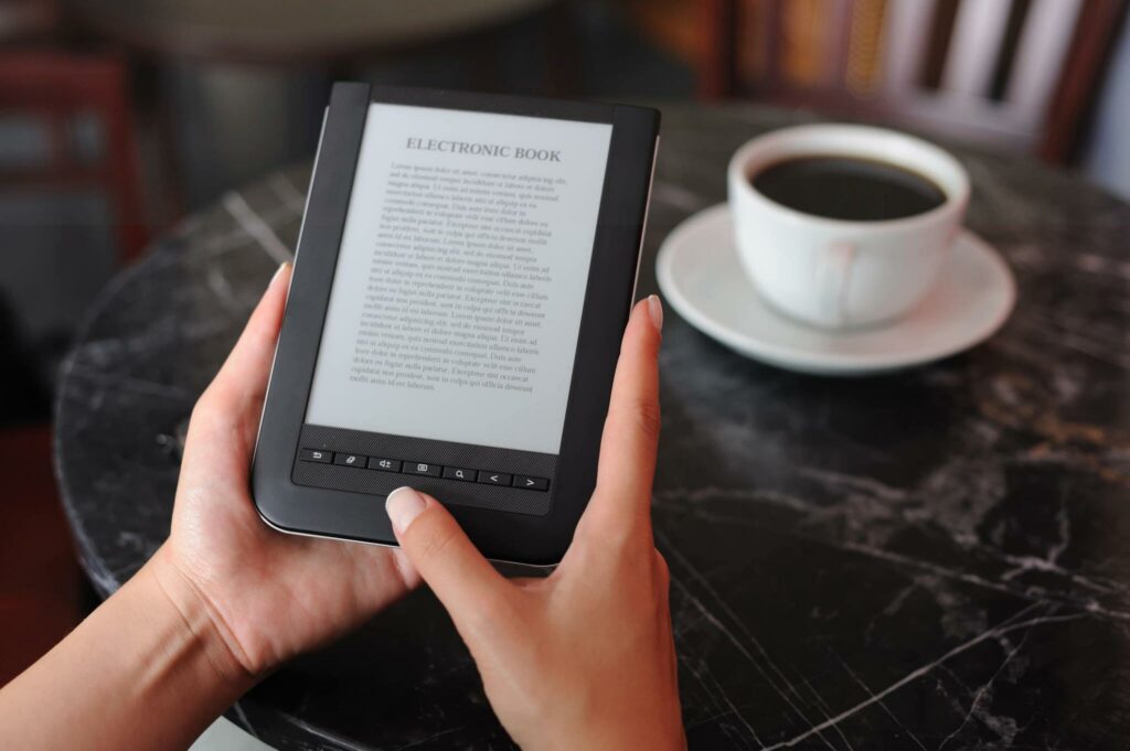 Woman reading e-book in a coffee shop. (e-book text is LOREM IPSUM fake language)