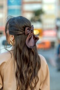 Ribbon visible from behind woman walking in the city