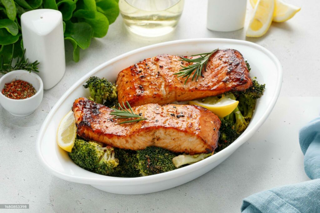 Salmon. Baked, roasted fish steaks, slices. Grilled salmon,trout fillet fish in marinade with broccoli in baking dish. Diet, meal, dinner.