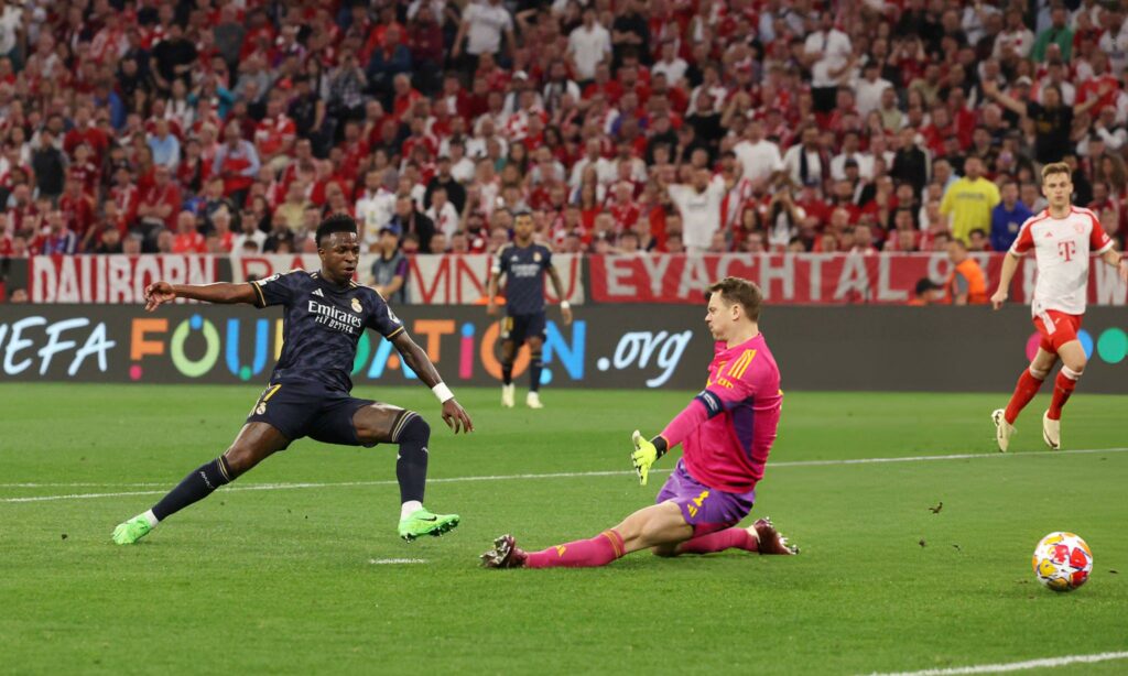 MUNICH, GERMANY - APRIL 30: Vinicius Junior of Real Madrid scores his team's first goal past Manuel Neuer of Bayern Munich during the UEFA Champions League semi-final first leg match between FC Bayern München and Real Madrid at Allianz Arena on April 30, 2024 in Munich, Germany. (Photo by Alexander Hassenstein/Getty Images)