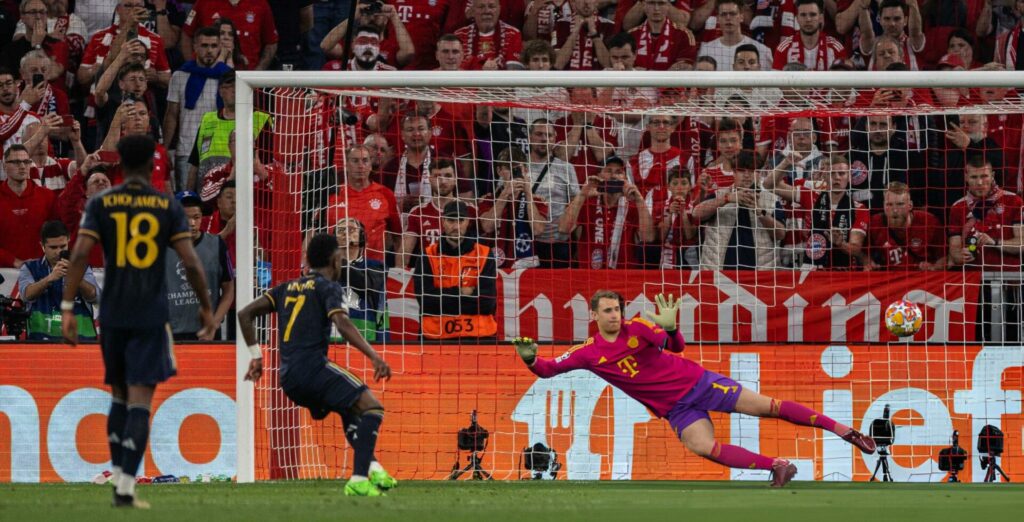 MUNICH, GERMANY - APRIL 30: Vinicius Junior of Real Madrid scores his team's second goal past goalkeeper Manuel Neuer of FC Bayern Muenchen by penalty during the UEFA Champions League semi-final first leg match between FC Bayern München and Real Madrid at Allianz Arena on April 30, 2024 in Munich, Germany. (Photo by Boris Streubel/Getty Images)