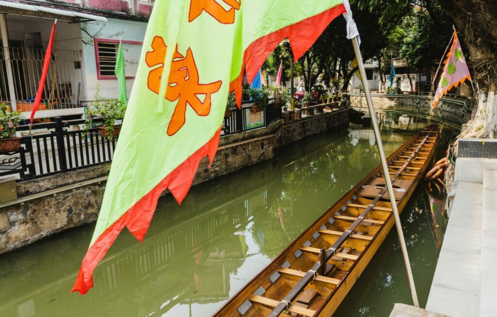 Chinese dragon boat parked on canal of a village